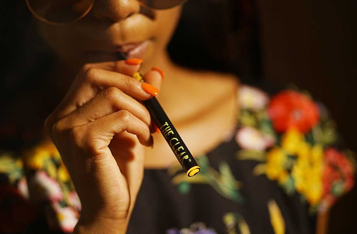 Women Vaping a Vape Pen filled with Cannabis
